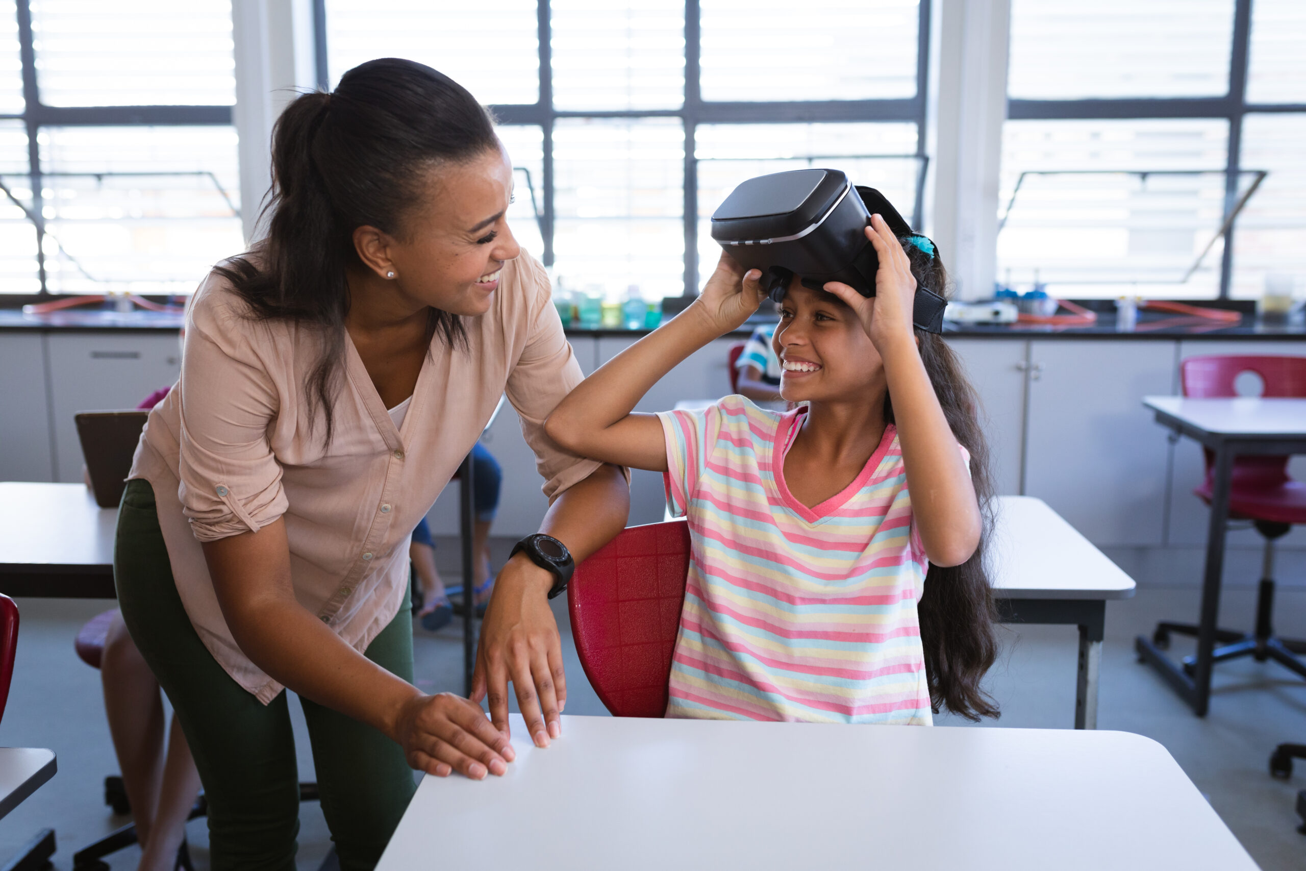 Girl with VR Headset on next to a teacher